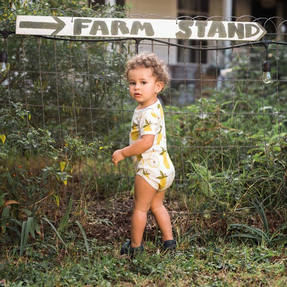 Little Baby on a Farm Wearing an Organic One Piece or Onesie in the Pear Fruit Print by Milkbarn Kids