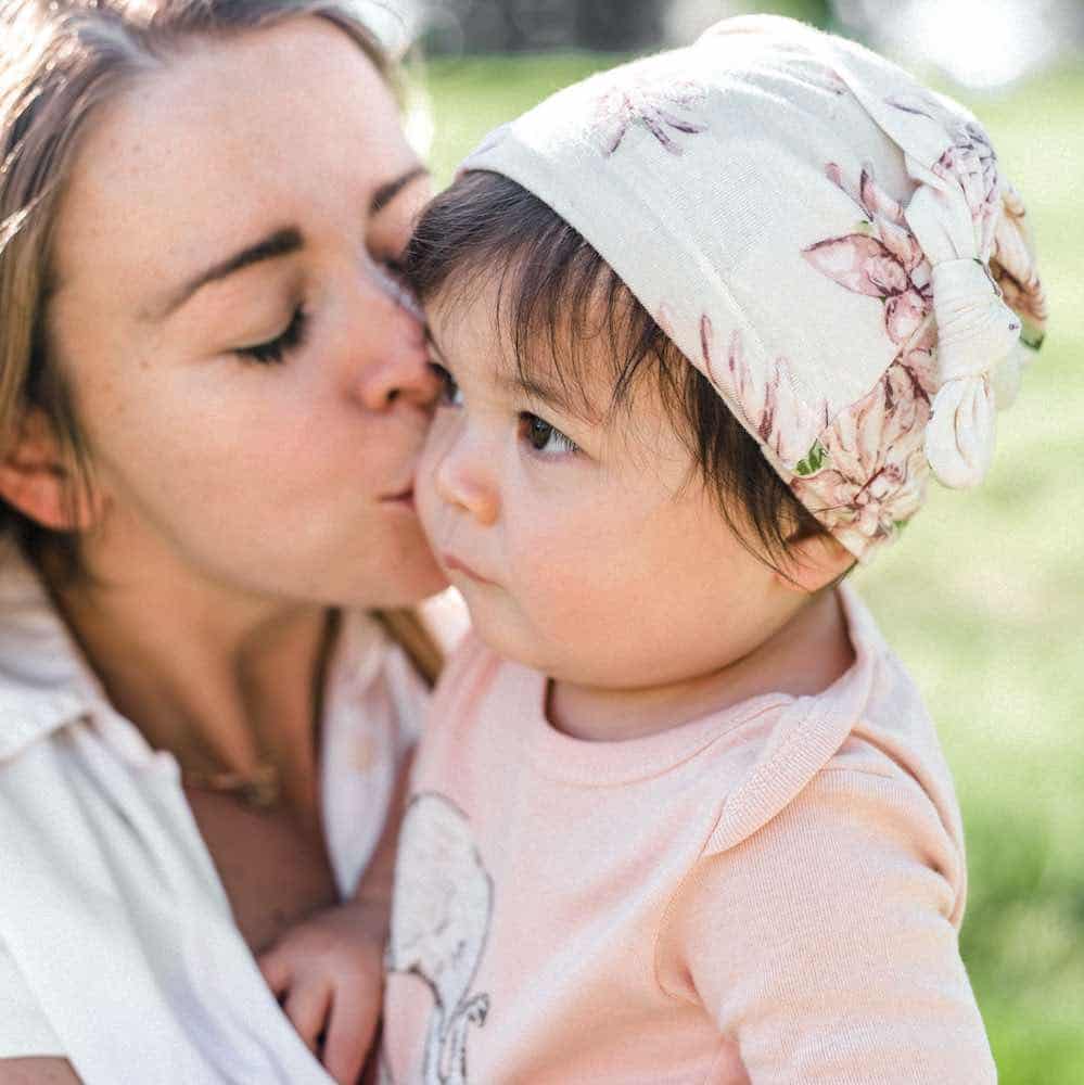 Mom and Little Baby Girl Wearing the Bamboo Knotted Hat in the Water Lily Print by Milkbarn Kids
