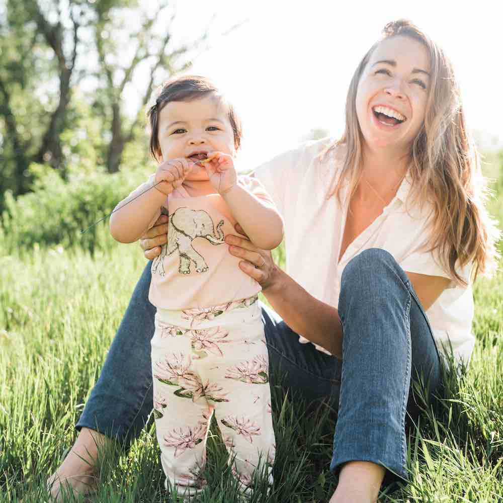 Mom and Little Baby Girl Wearing Bamboo Leggings in the Water Lily Print and the Organic Cotton Applique One Piece in the Tutu Elephant by Milkbarn Kids