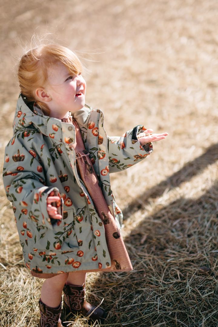 Young girl modeling open Apple Orchard print nylon three-in-one autumn winter jacket, front view