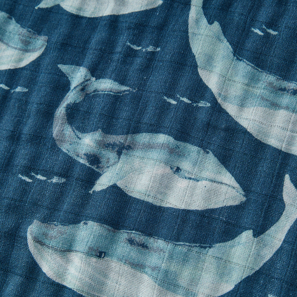 Detailed close-up of soft, dark blue fabric of Milkbarn’s Blue Whale Big Lovey blanket