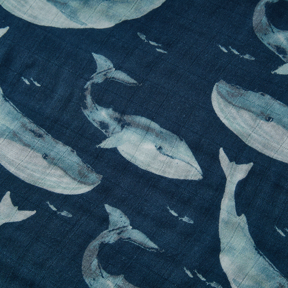 Closeup of Milkbarn Blue Whale Mini Lovey Two-Layer Muslin Security Blanket fabric, breathable bamboo cotton muslin with playful whale design