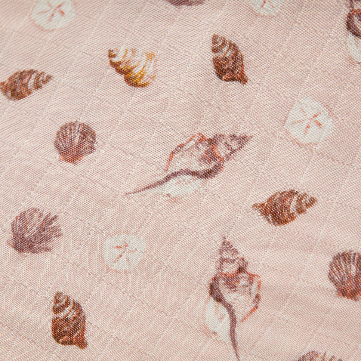 Closeup of Milkbarn Seashells Big Lovey Blanket, breathable three-layer bamboo and cotton muslin fabric with seashell and sand dollar print for baby comfort