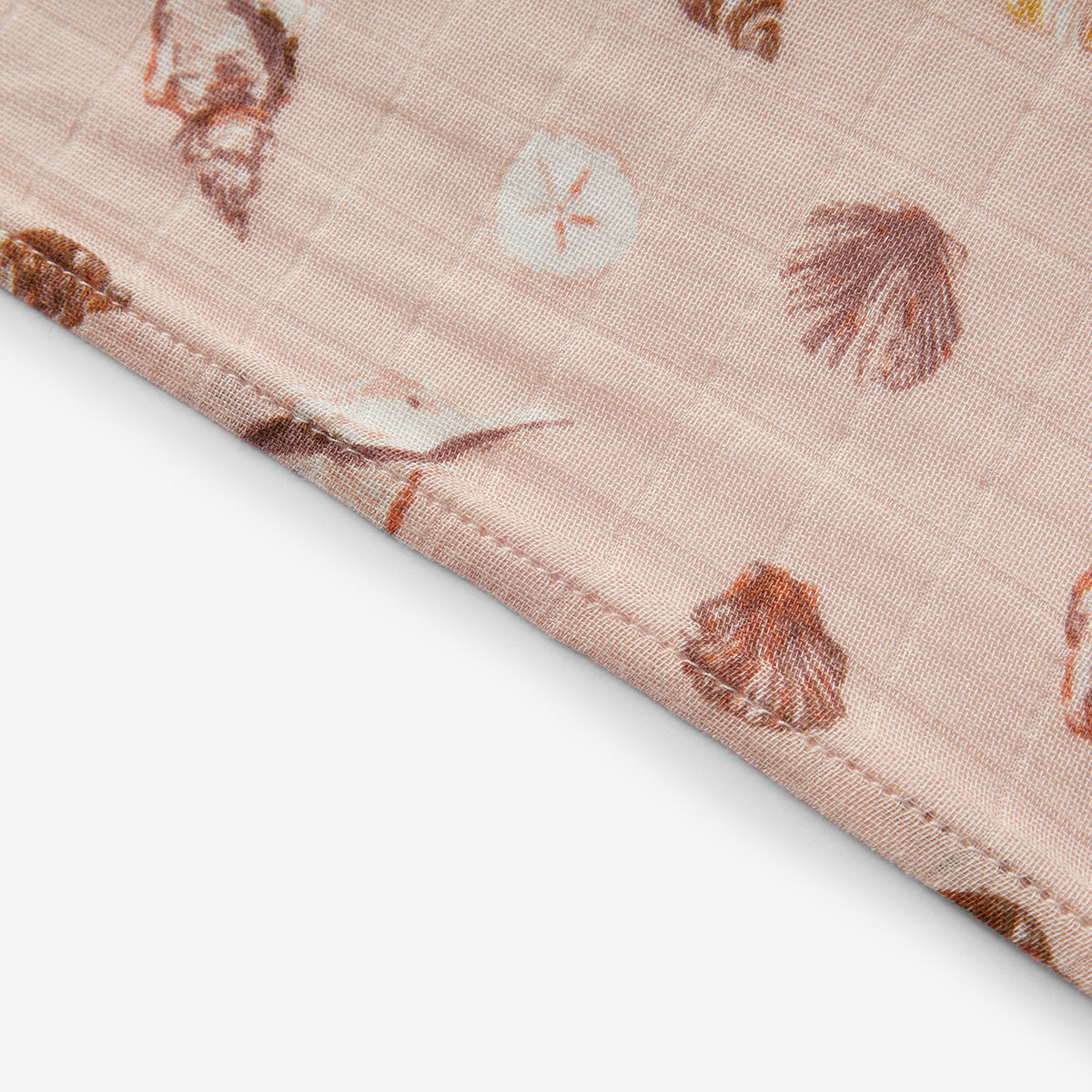 Closeup of Milkbarn Seashells Bamboo Muslin Burp Cloths, showing soft 70% rayon bamboo and 30% cotton fabric with secure stitching and beach-themed seashell and sand dollar print