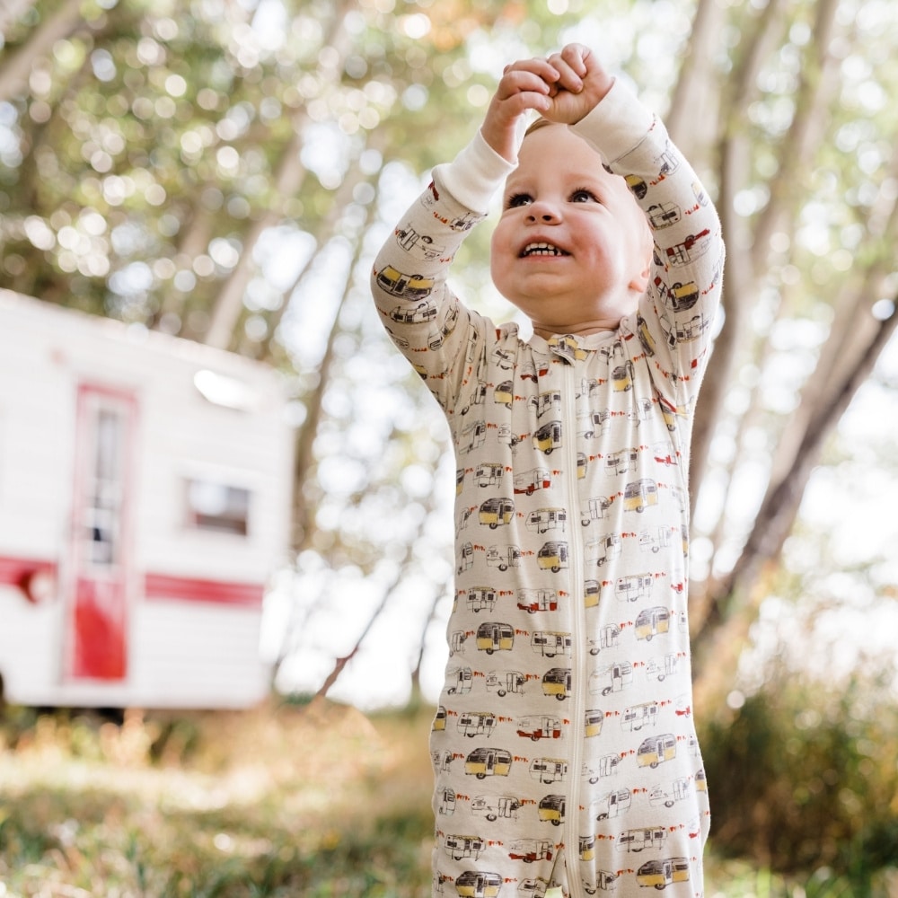 Baby Boy Wearing the Organic Cotton Vintage Trailers Zipper Pajamas by Milkbarn Kids