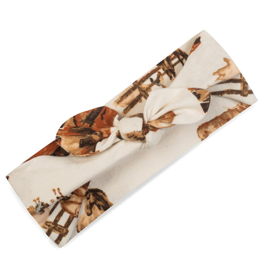 Baby girl organic cotton knotted bow headband, cream fabric with farm animals including barn, horse, cow, chicken, and pig