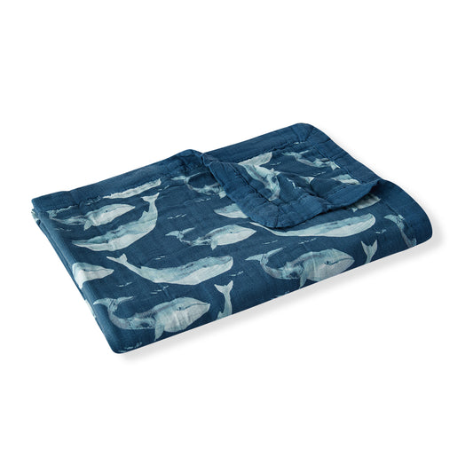 Folded Milkbarn Blue Whale Big Lovey blanket highlighting plush dark blue fabric and soft texture