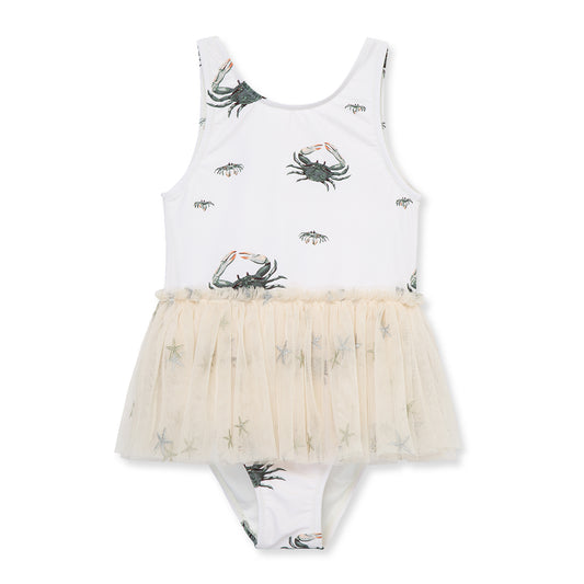 Milkbarn’s Coastal Crab Ballet Skirt Swimsuit featuring playful sea-green crabs on a neutral base, UPF 50+ nylon spandex blend for comfort and protection