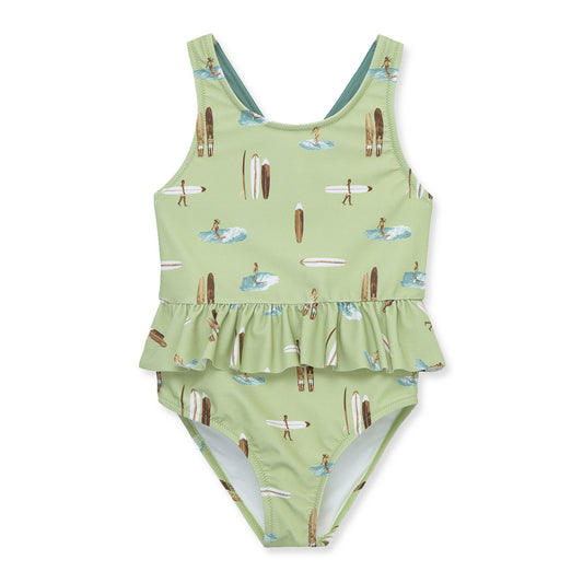 Milkbarn Summer Surf ruffle waist cross-back swimsuit for baby girls, surfer print, soft stretch nylon blend with UPF 50+ protection.