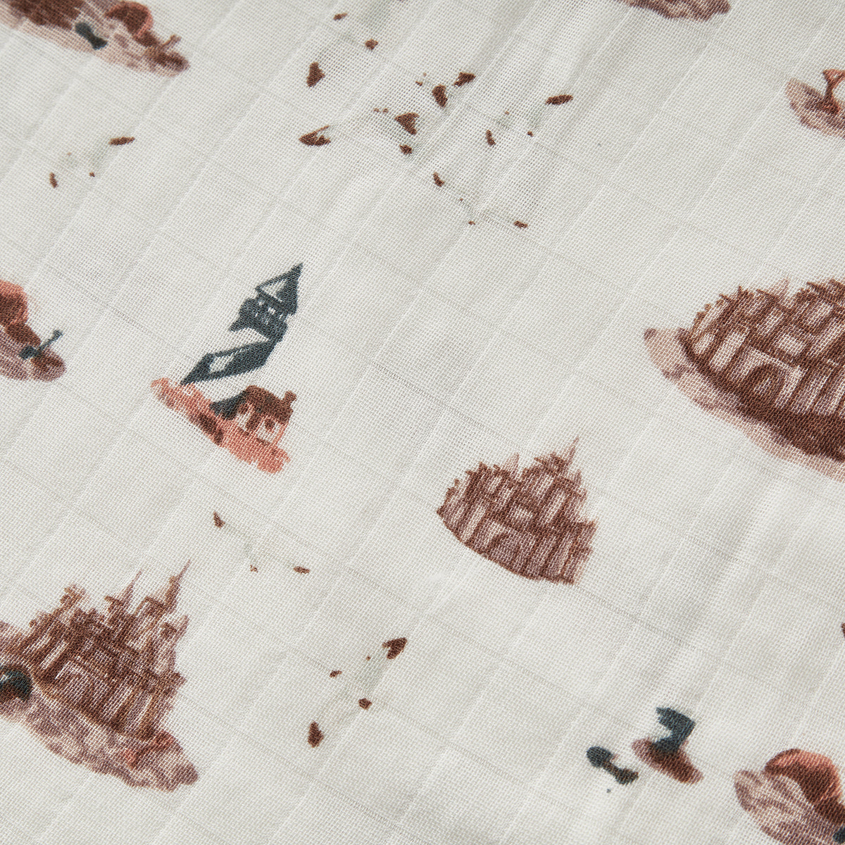 Closeup of Milkbarn Sandcastle Big Lovey Blanket, breathable three-layer bamboo and cotton muslin fabric with soft sandcastle, lighthouse, and seagull print
