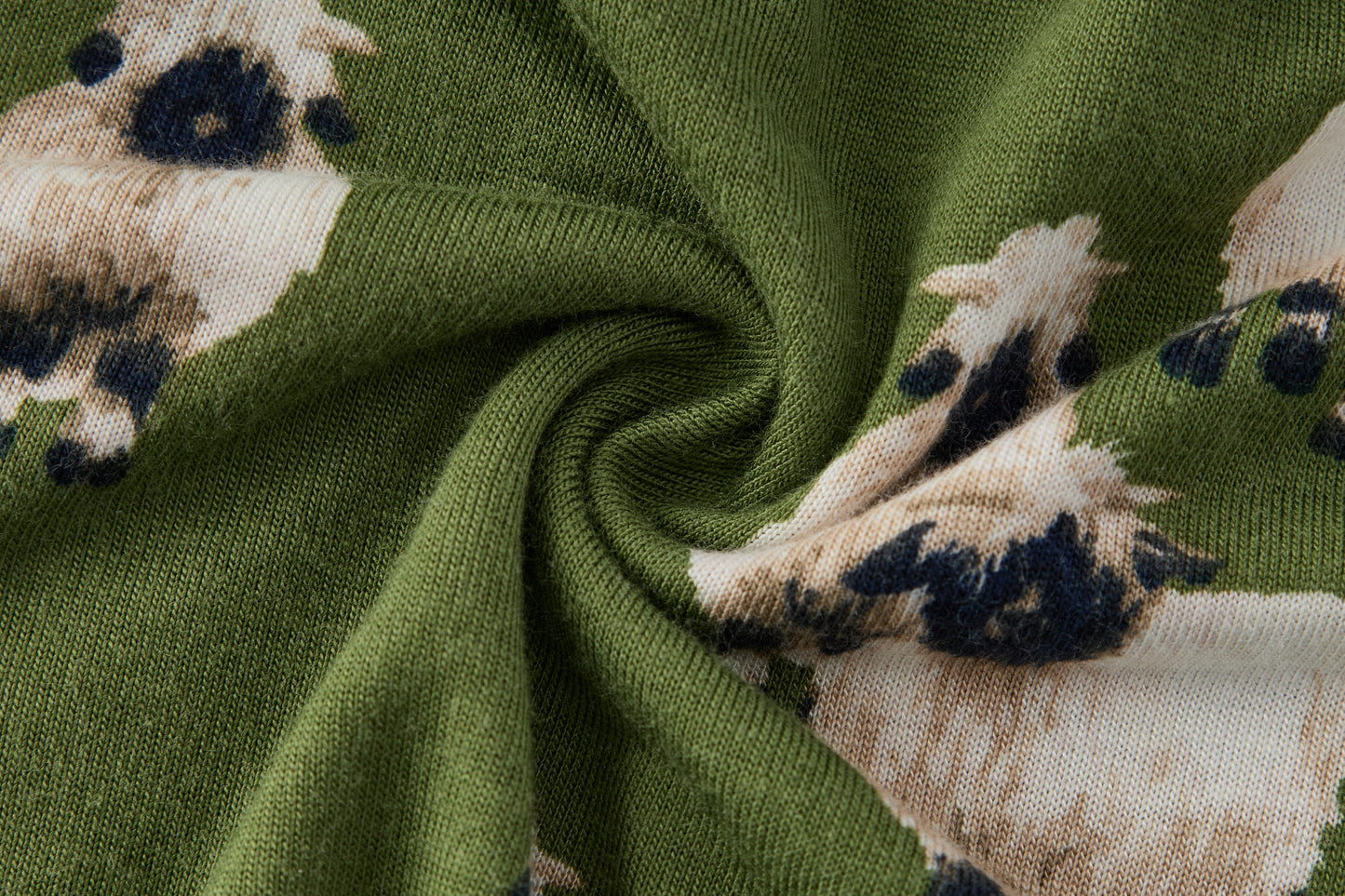 Closeup of soft breathable rayon from bamboo fabric on Milkbarn Valais Sheep Dress and Bloomer Set, green eco-friendly material with black-faced white sheep print