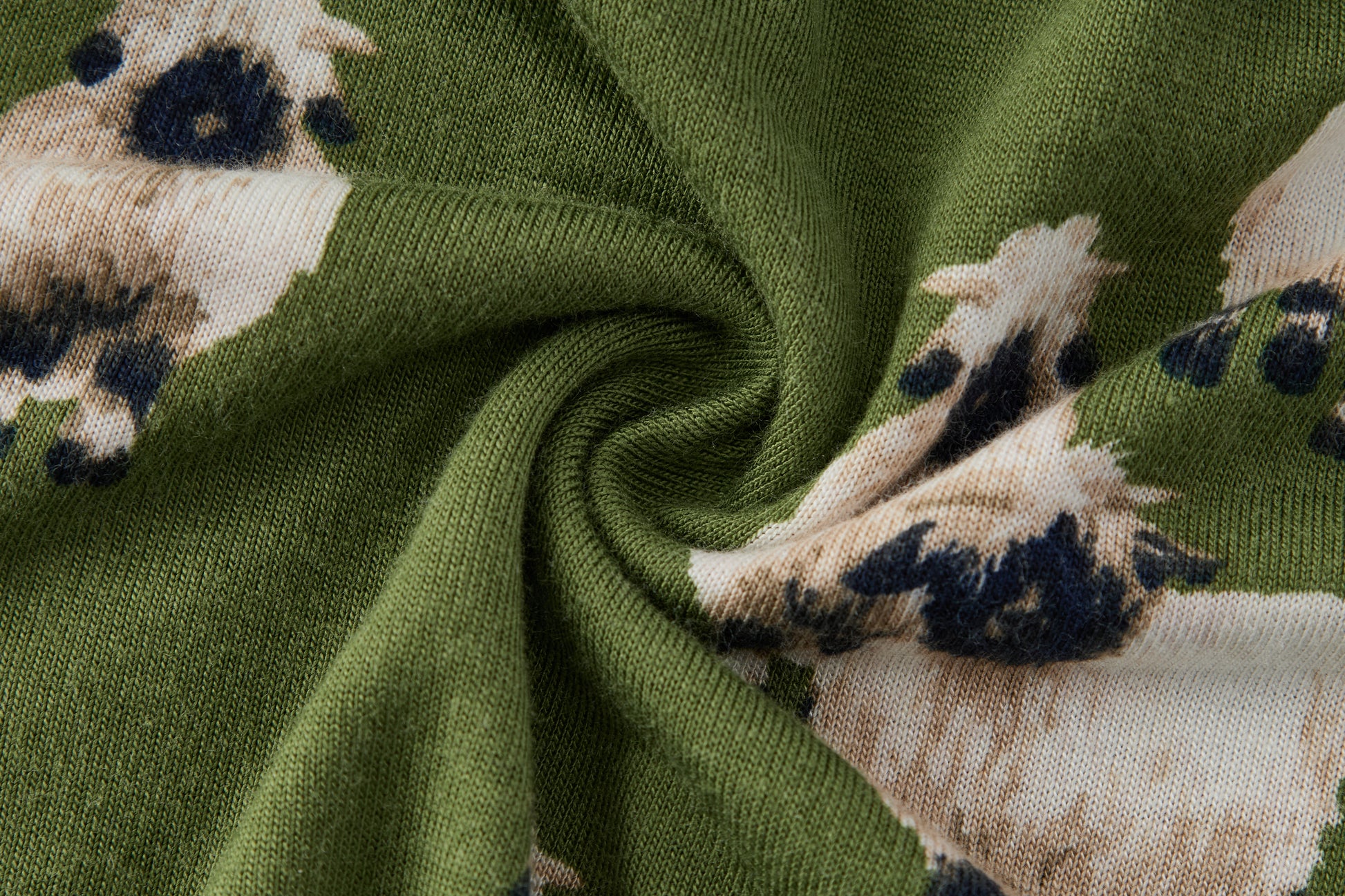 Closeup of soft breathable rayon from bamboo fabric on Milkbarn Valais Sheep Dress and Bloomer Set, green eco-friendly material with black-faced white sheep print