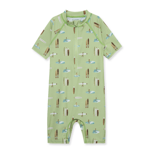 Milkbarn Summer Surf zipper shortall swimsuit in green with surfer designs, UPF 50+ sun protection for active babies and toddlers.