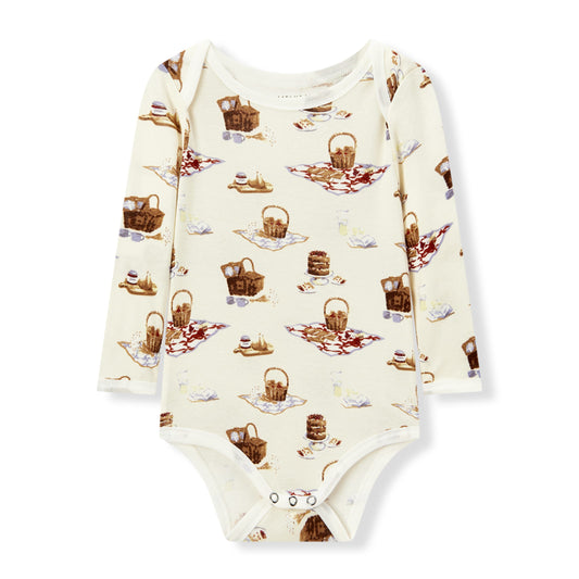 Soft and hypoallergenic organic cotton long sleeve baby one piece in white with playful picnic print