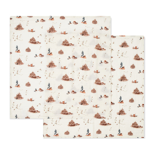 Two-piece organic cotton muslin baby burp cloth set with white sandcastle and lighthouse prints, soft and absorbent for newborns, perfect for beach-loving baby gifts