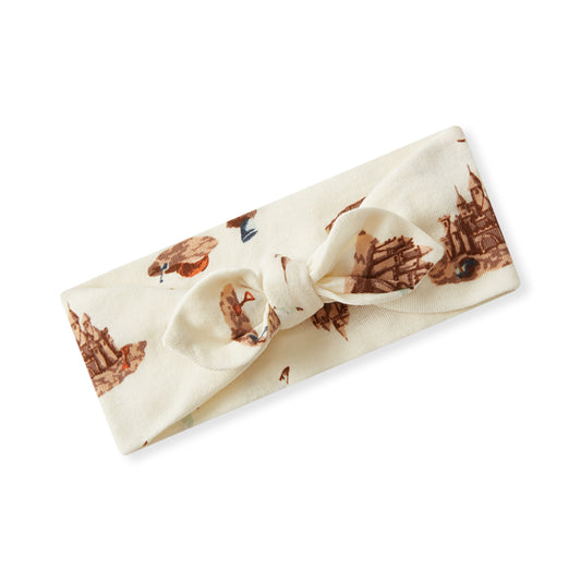 Baby girl organic cotton knotted bow headband, cream fabric with beach day print including sandcastle, seagulls, and beach toys