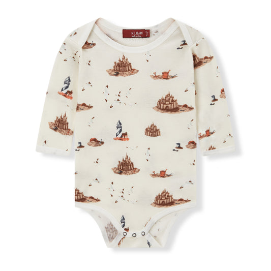 Soft and hypoallergenic organic cotton long sleeve baby one piece in white and brown with sandcastle beach print