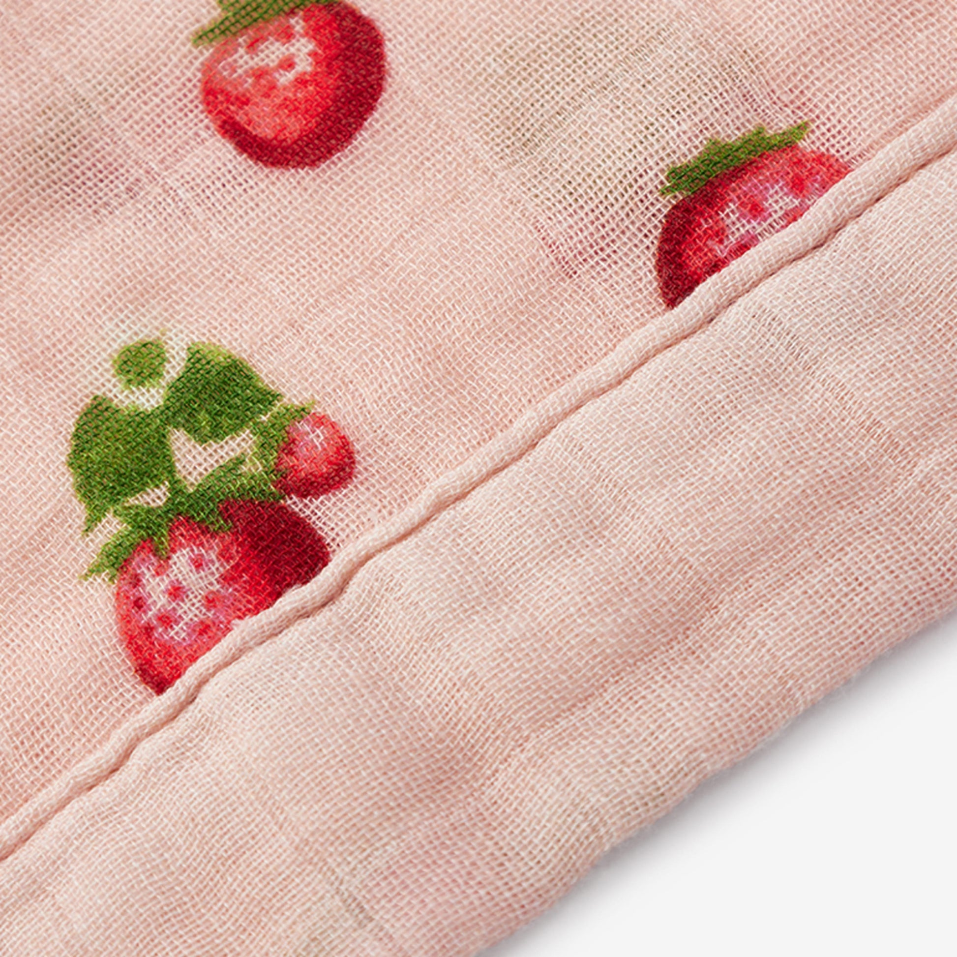 Closeup of Strawberry Bamboo Mini Lovey muslin fabric and trim detail