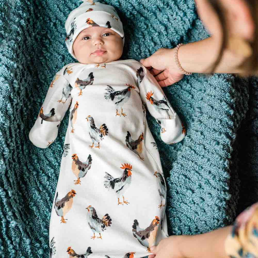 Mom and Little Newborn Baby Wearing a Organic Cotton Gown and Hat Set in the Chicken and Rooster Print by Milkbarn Kids