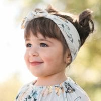 Baby Girl Wearing the Butterfly Bamboo Knotted Headband by Milkbarn Kids