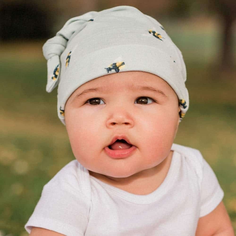 Baby Wearing the Bumblebee Bamboo Knotted Hat by Milkbarn Kids
