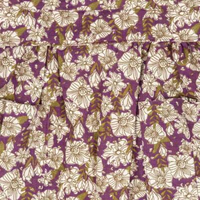 Purple Floral Detail of the Organic Pinafore Apron by Milkbarn Kids
