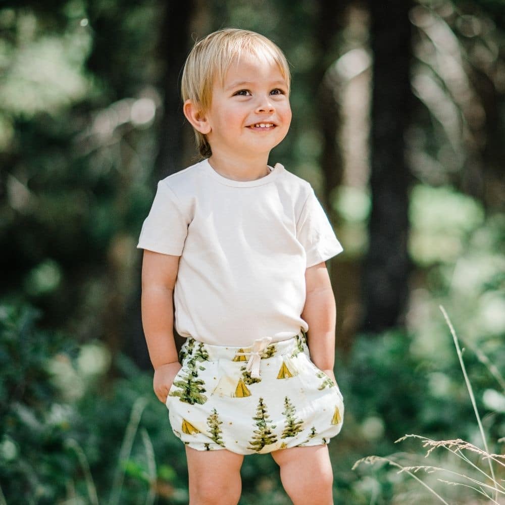 Little Boy in the Forest wearing the Camping Bamboo Pocket Bloomer by Milkbarn Kids