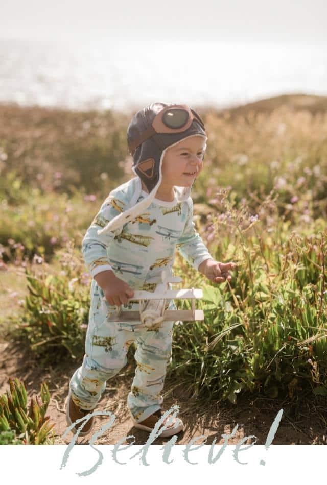 Milkbarn A Wonder Above - Believe Like this little boy running in a field near the ocean wearing the Vintage Planes print