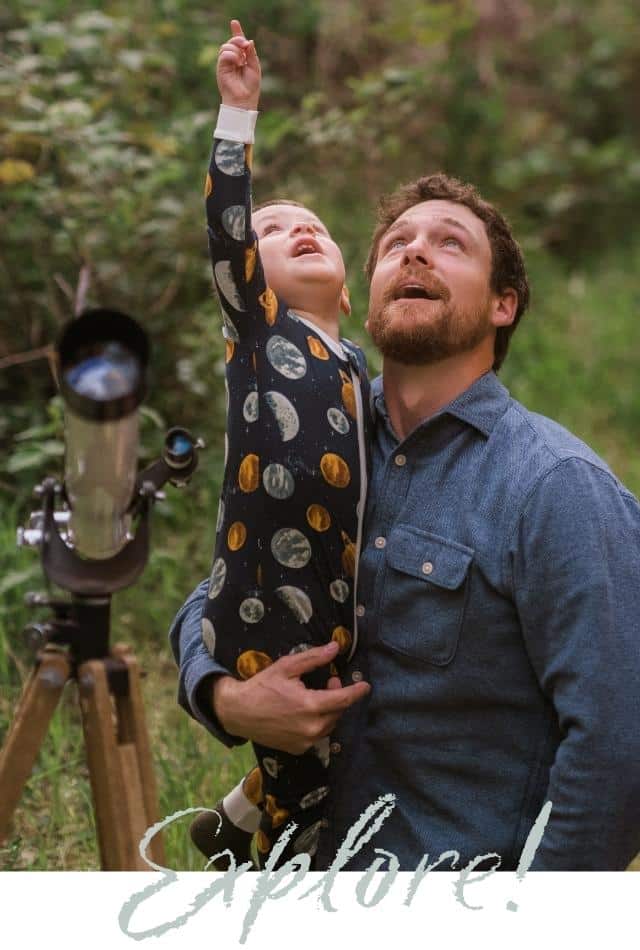 Milkbarn A Wonder Above-Explore: A father and son look up to the stars and planets with a telescope while wearing the Planets print