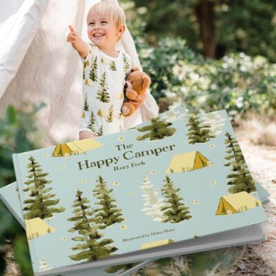 Photo of cover artwork of The Happy Camper by Rory Feek with Lifestyle image of baby boy wearing a bamboo one piece in the camping print by Milkbarn Kids